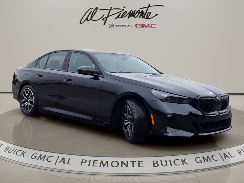 2026 BMW i5 xDrive40 in Carbon Black Metallic — front three-quarter view